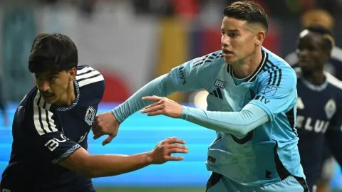 James Rodriguez u svijetlo plavom dresu u duelu s protivničkim igračem na utakmici.