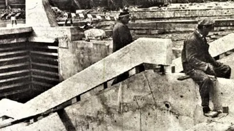 Crno-bijela fotografija radnika na gradilištu betonskog pothodnika