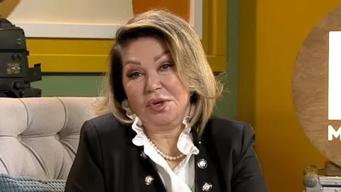 Portret pjevačice Nede Ukraden u crnom saku i bijeloj bluzi s bisernim ogrlicom