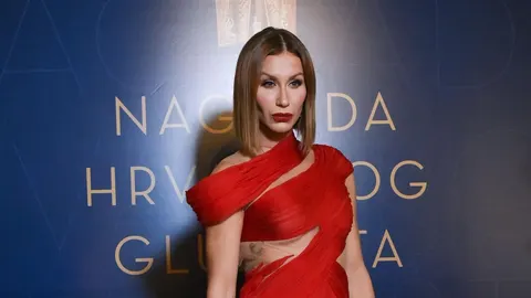 Glumica Ana Gruica Uglešić u crvenoj haljini ispred plave pozadine