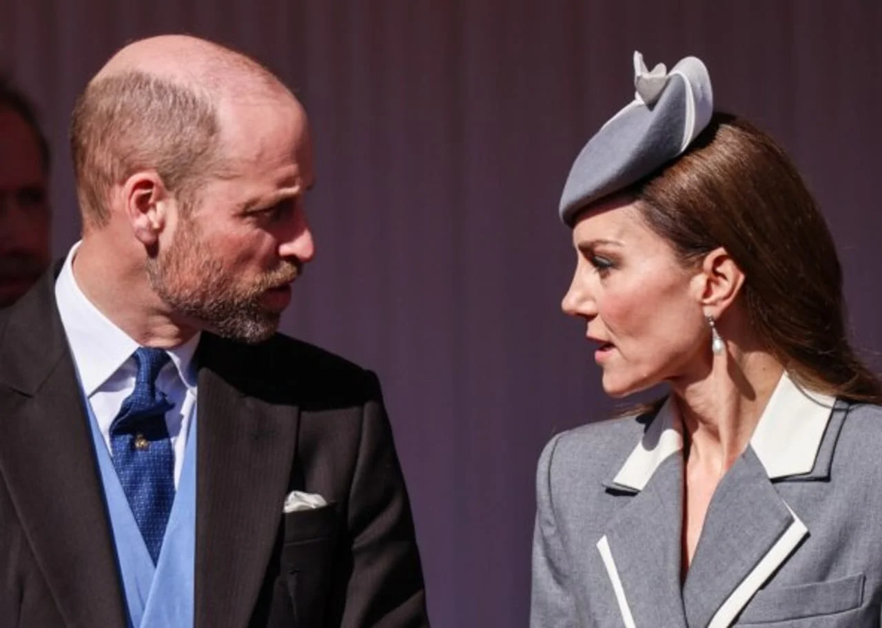 Kate Middleton u sivoj odjeći razgovara s muškarcem