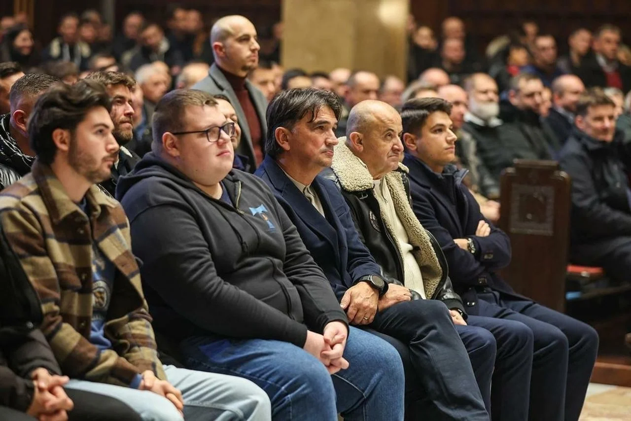 Zlatko Dalić sjedi u prvom redu među skupinom muškaraca