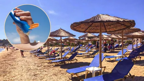 Plajžani sunčadori i kišobran od slamke uz ruku koja nanosi kremu za sunce