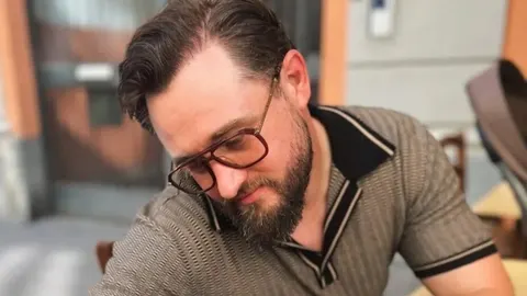 Portret glazbenika Matije Cveka s naočalama i bradom