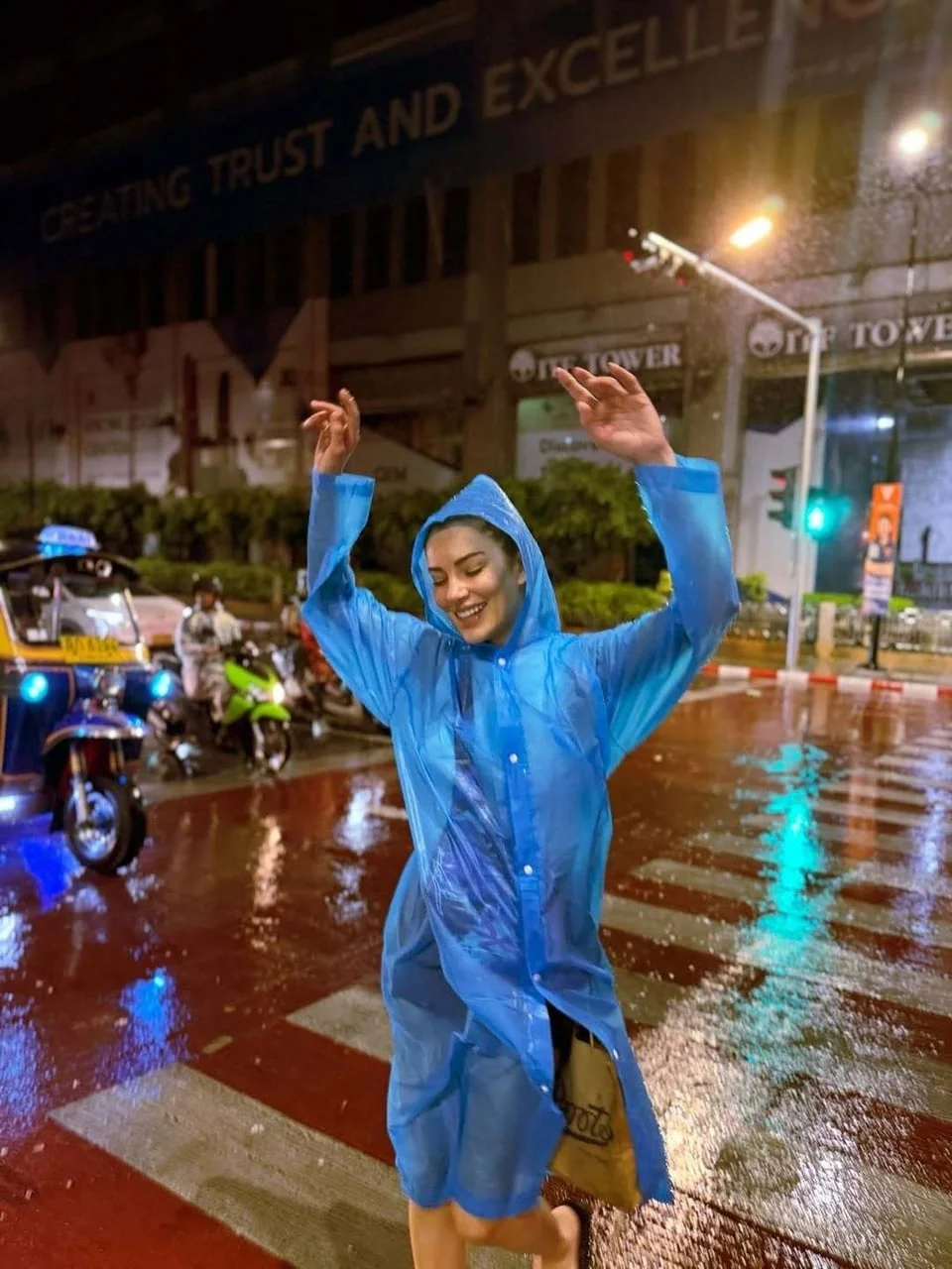 Ece İrtem u plavoj kabanici na kišnom ulicy u gradu