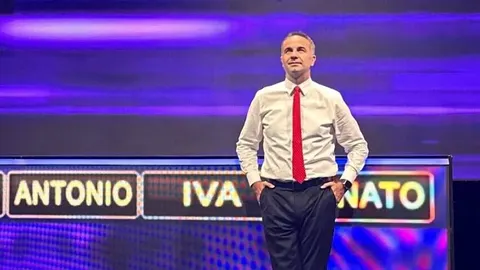 Joško Lokas u bijeloj košulji i crvenoj kravati na pozornici