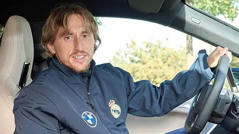 Luka Modrić sjedi za upravljačem automobila u plavoj jakni