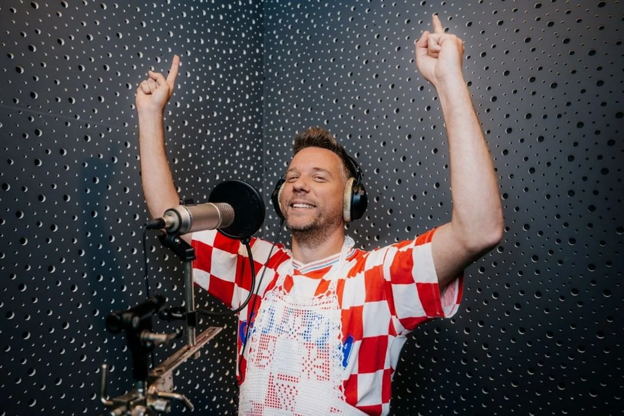 Muškarac sa slušalicama i kockastim uzorom u studiju