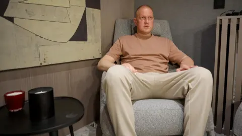 Ivan Klasnić sjedi u sivoj fotelji u kućnom okruženju.