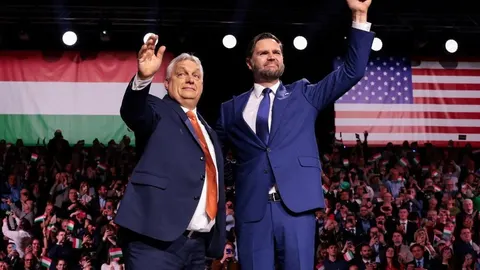 Viktor Orbán i J.D. Vance mašu publici ispred mađarske i američke zastave.