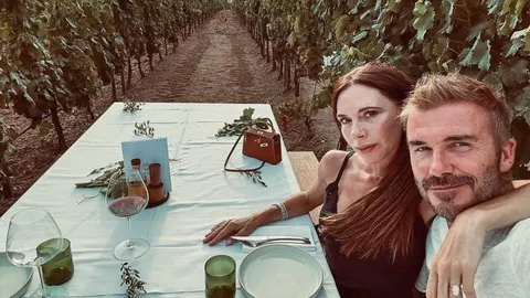 Victoria i David Beckham sjede za stolom u vinogradu