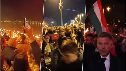 Peter Magyar u masi pristaša s mađarskim zastavama i upaljenim bakljama noću.