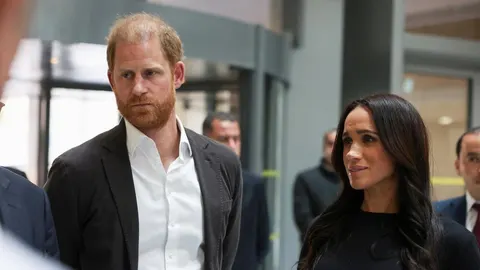 Princ Harry i Meghan Markle na javnom događaju u zatvorenom prostoru.