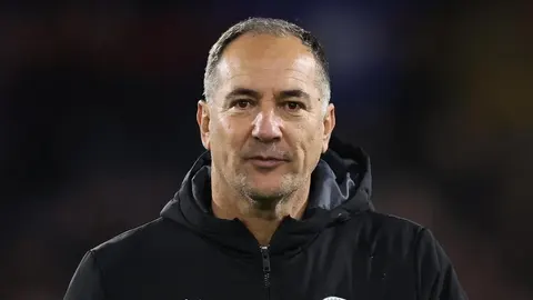 Portret Igora Štimca u crnoj sportskoj jakni s ozbiljnim izrazom lica.