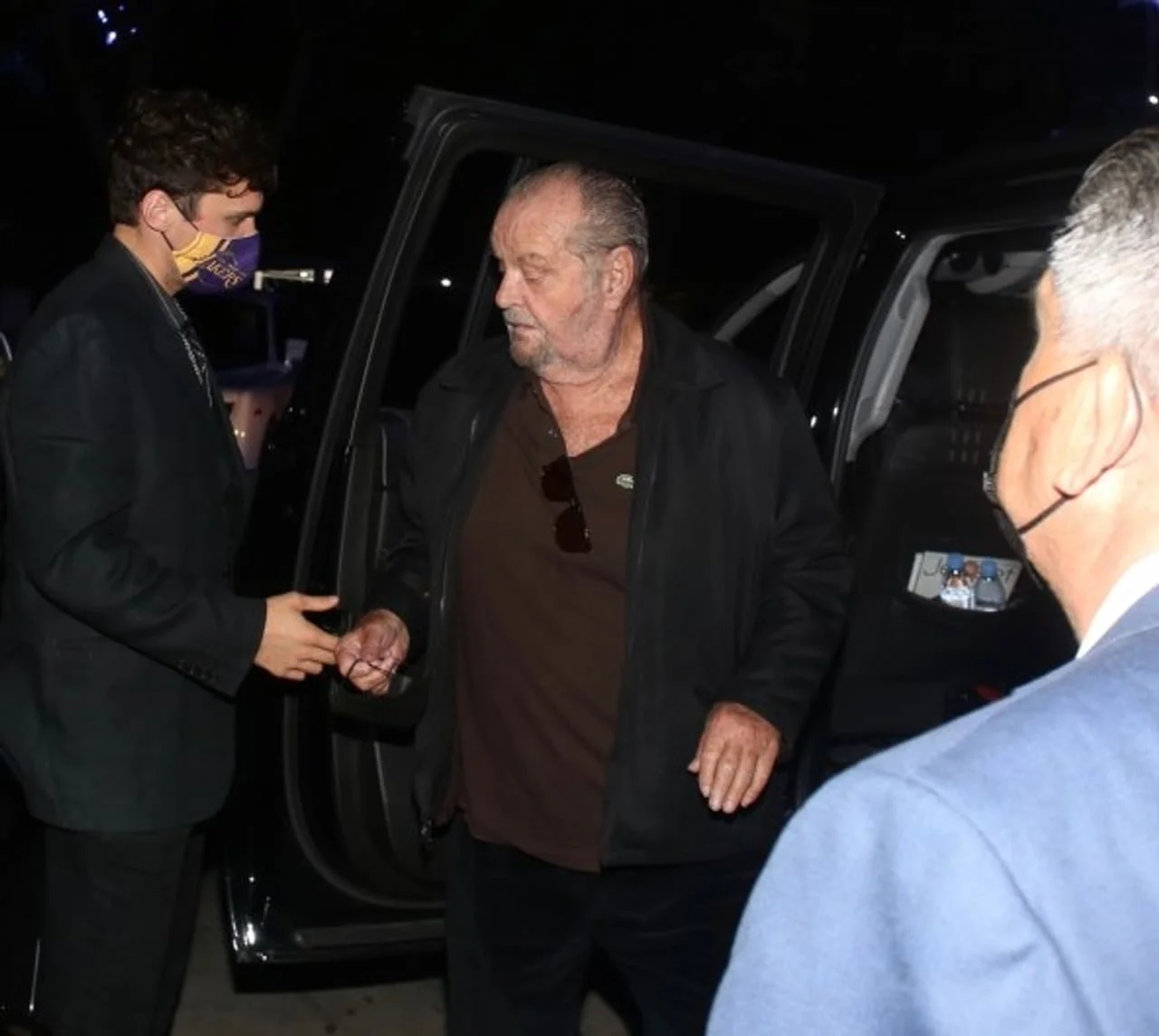 Jack Nicholson izlazi iz crnog automobila u pratnji mlađeg muškarca.