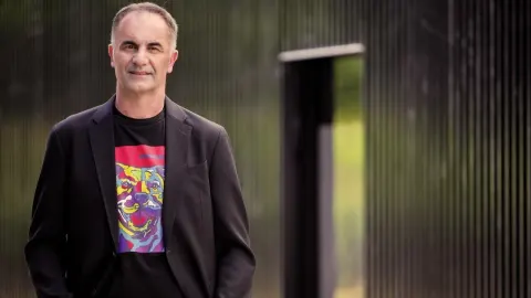 Voditelj Joško Lokas u crnom sakou i majici s printom psa