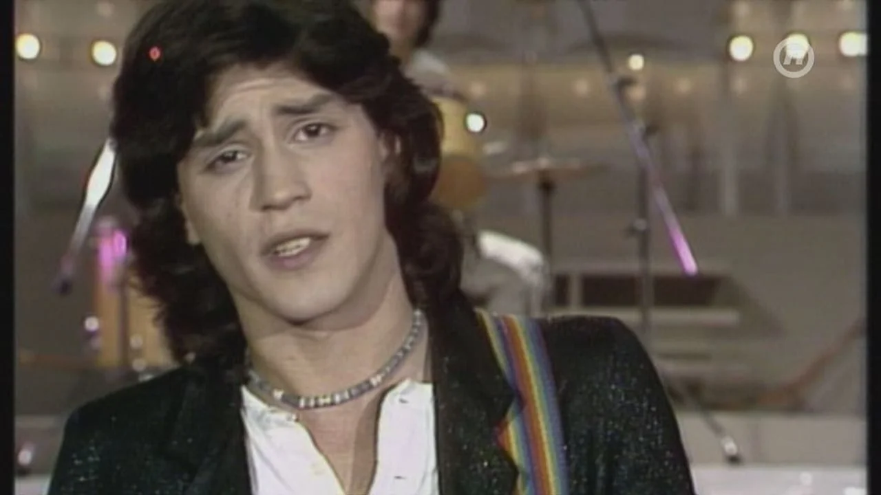 Arhivska snimka mladog Vlade Kalembera s gitarom na pozornici