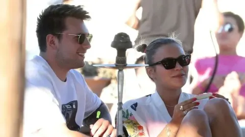 Luka Dončić i Anamaria Goltes sjede zajedno na otvorenom sa sunčanim naočalama.