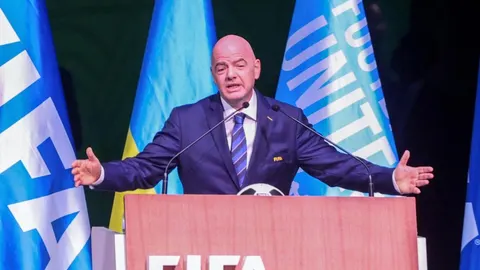 Gianni Infantino za govornicom s FIFA zastavama u pozadini.